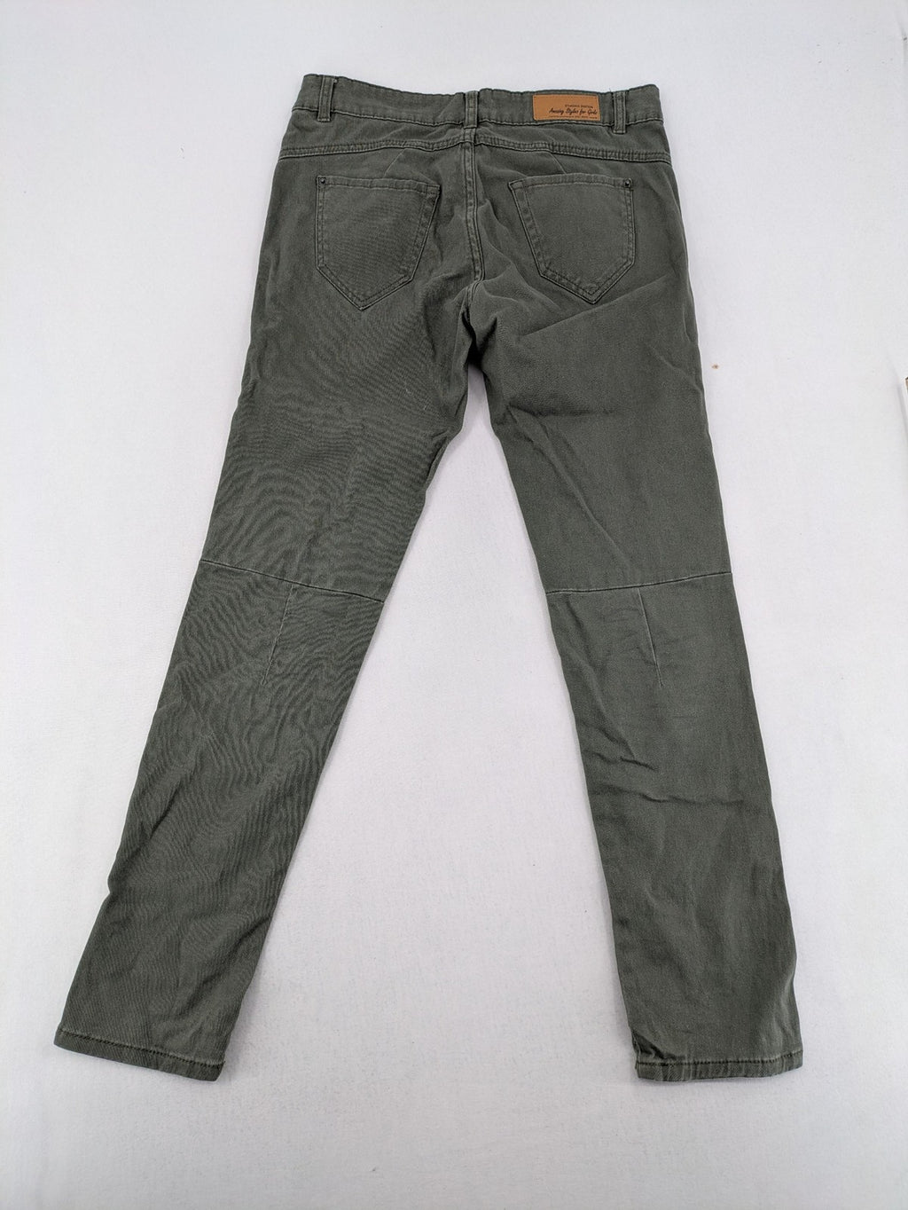 Page One Young khaki motorcycle pants with stitched panels and decorative zipper details.