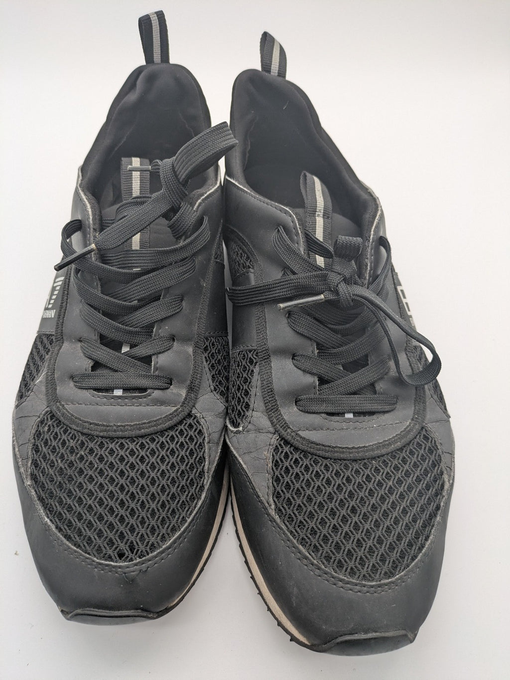 EA7 Emporio Armani beige and black sneakers with prominent EA7 branding and breathable mesh details.