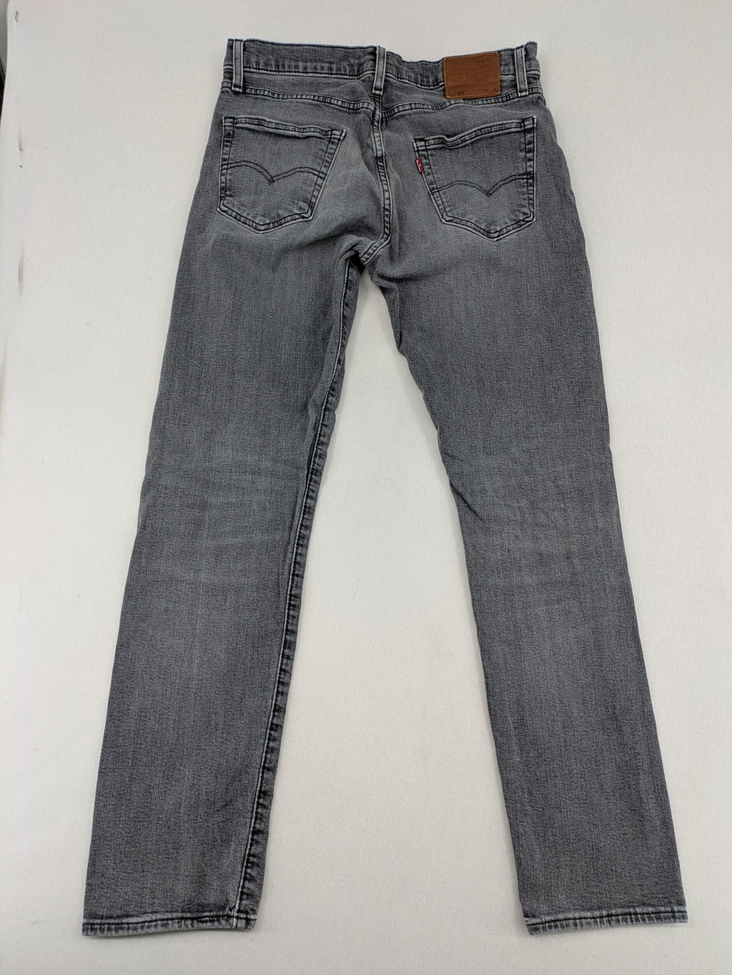Levi's red straight jeans with classic 5-pocket design and slim taper fit.