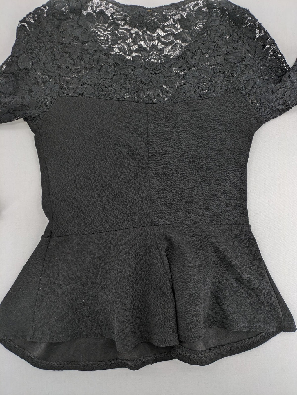 Amisu black peplum top with floral lace sleeves and delicate lace trim.