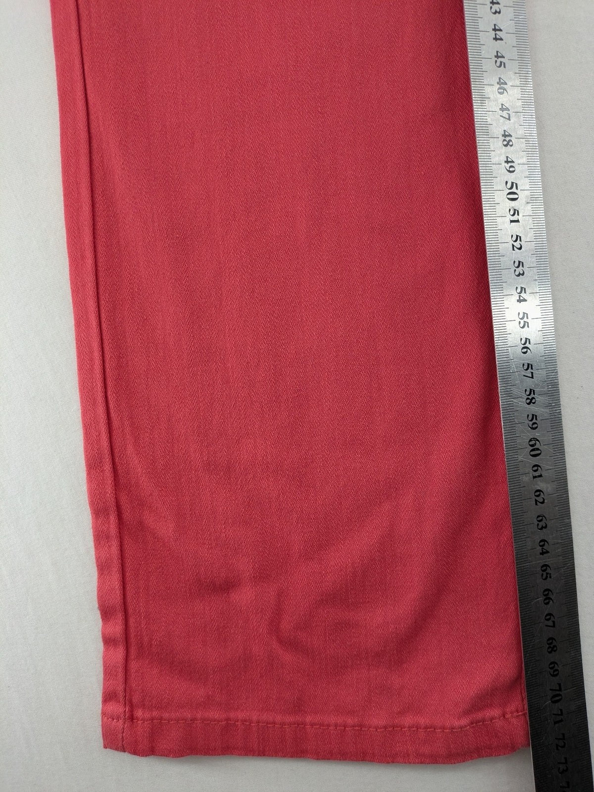 Helena Vera red straight jeans with elastic waistband and rhinestone details on pockets.