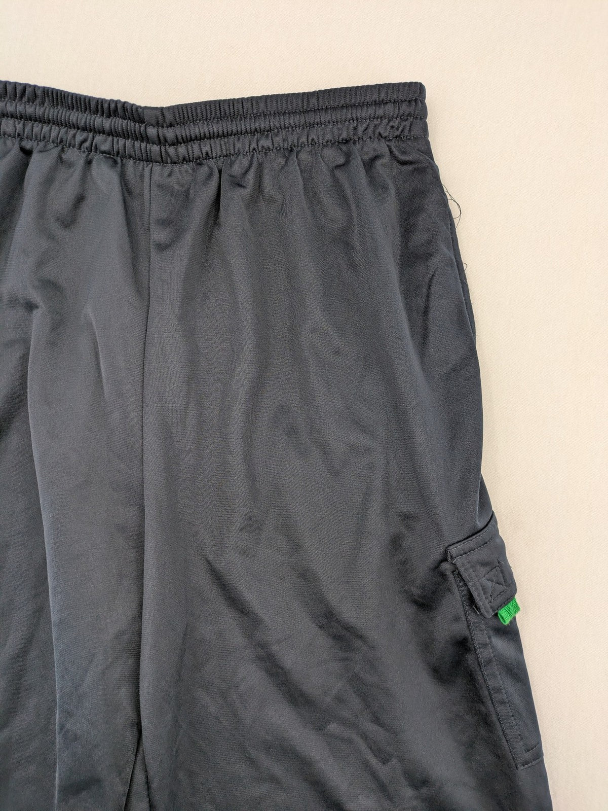 okay grey cargo shorts with green "ATHL. 5 DIVISION" graphic print and side pocket.