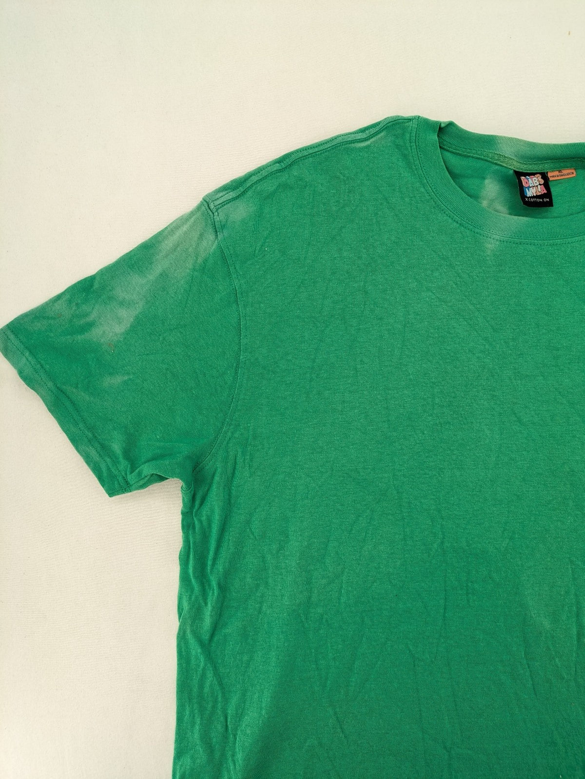 Myla green graphic t-shirt with large peace earth print and front pocket design.