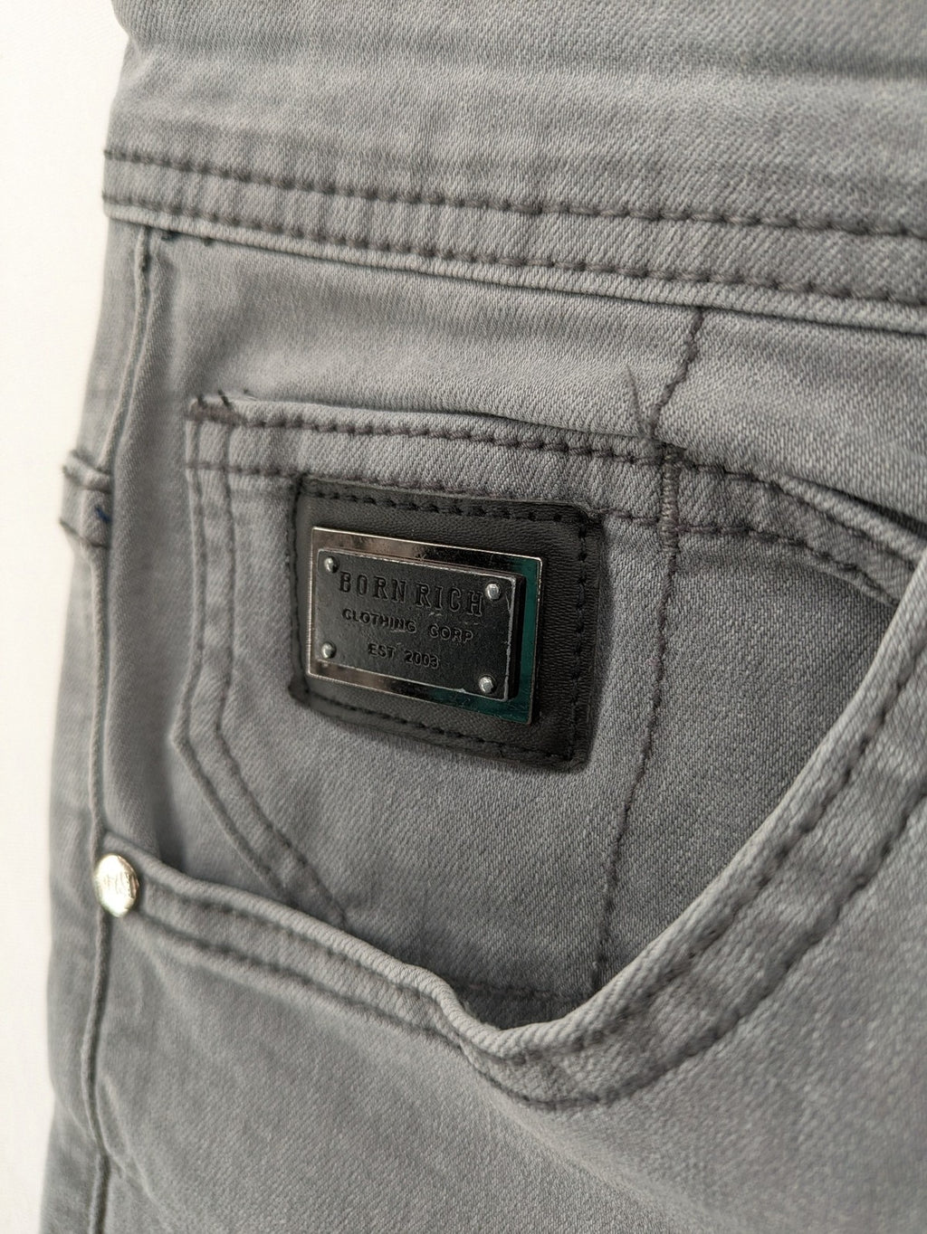 Born Rich grey slim fit jeans with logo patch and washed denim look.