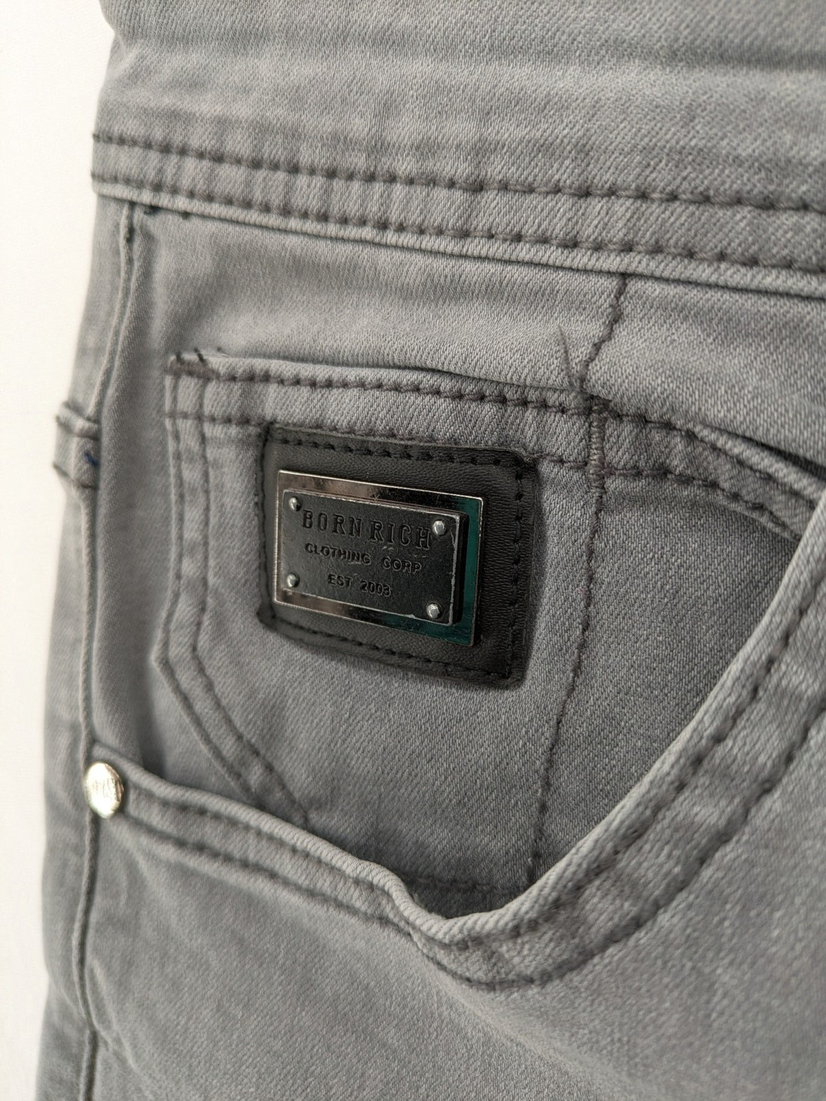 Born Rich grey slim fit jeans with logo patch and washed denim look.