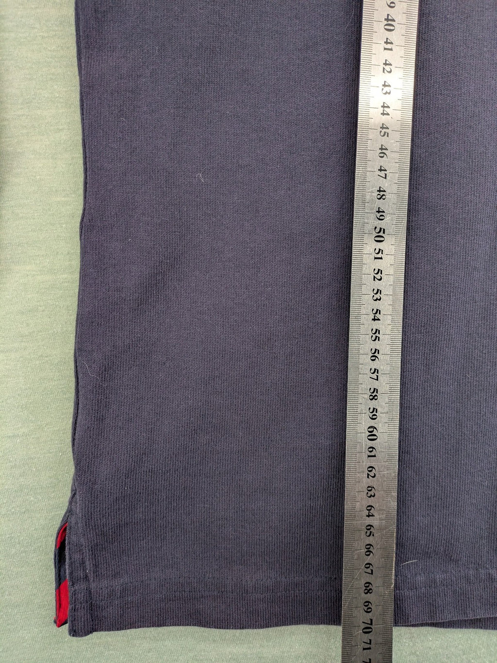 Tommy Hilfiger grey rugby polo shirt with navy striped collar and large H logo.