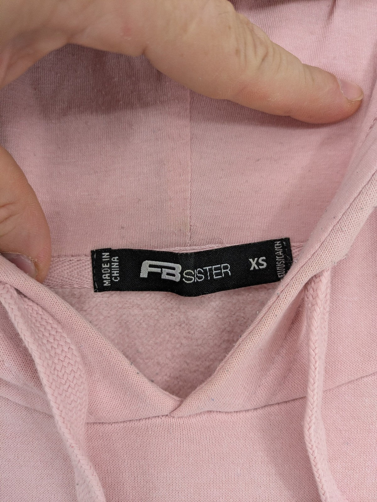FB Sister multi hoodie colorblock design pink, white, black with "COURAGEOUS" graphic print.