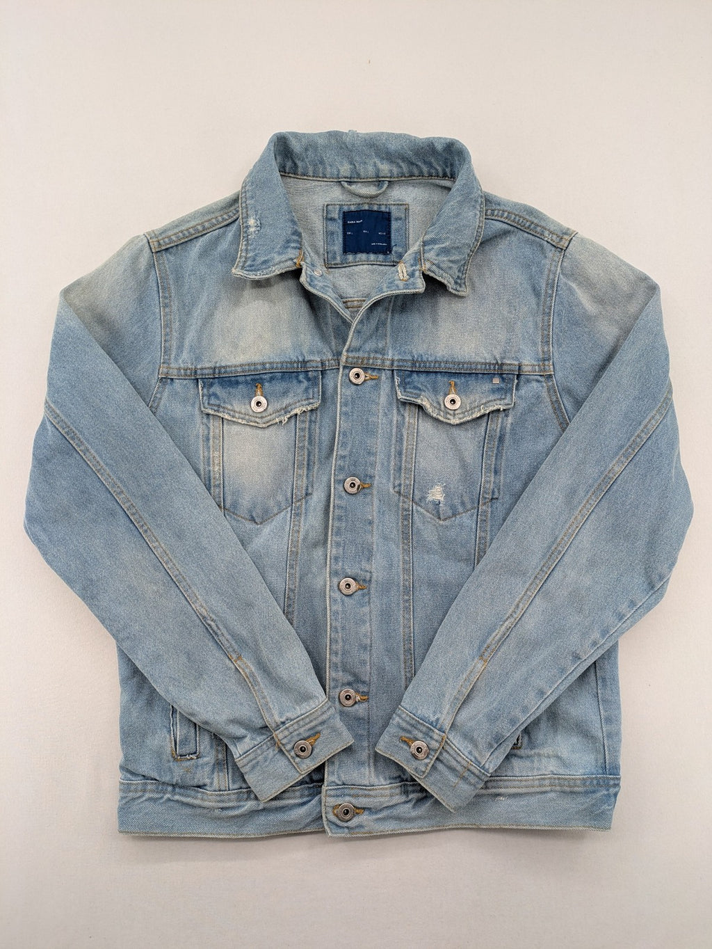 Zara Man blue denim jacket distressed with button closure and chest pockets.