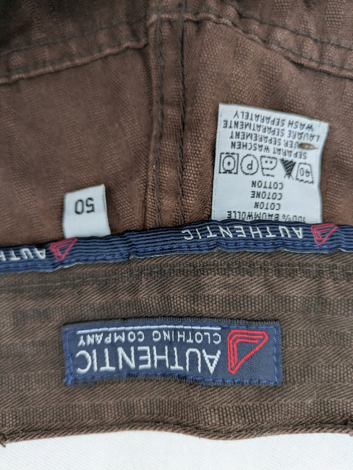 Authentic Clothing Company brown straight jeans with subtle stripe pattern and brand patch.