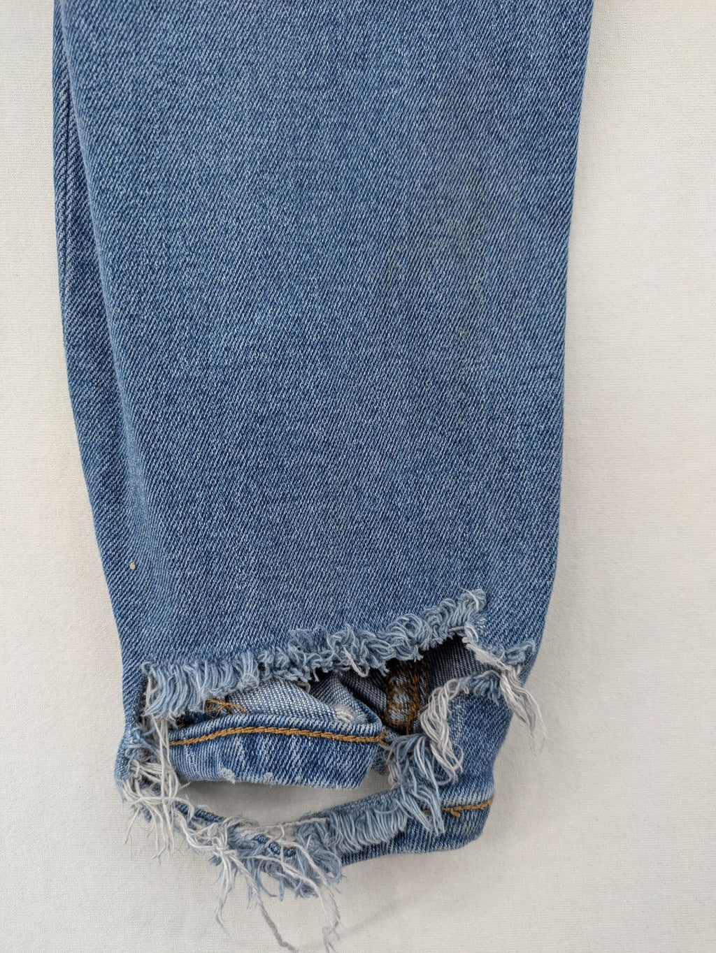 Pull&Bear blue carrot fit jeans with distressed knees and frayed hems.