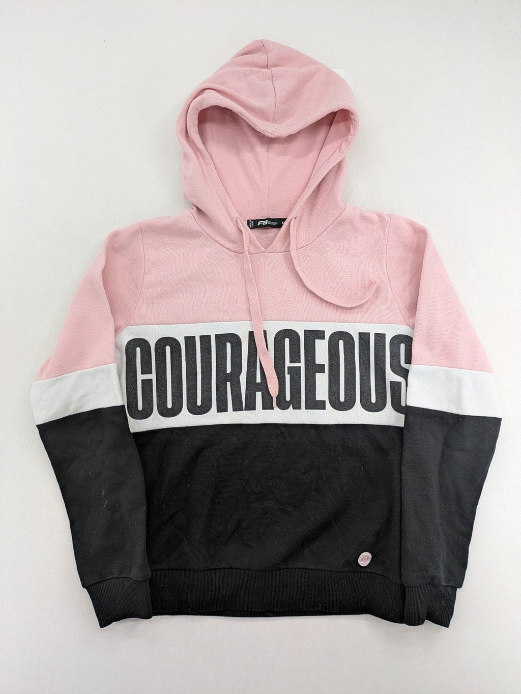 FB Sister multi hoodie colorblock design pink, white, black with "COURAGEOUS" graphic print.