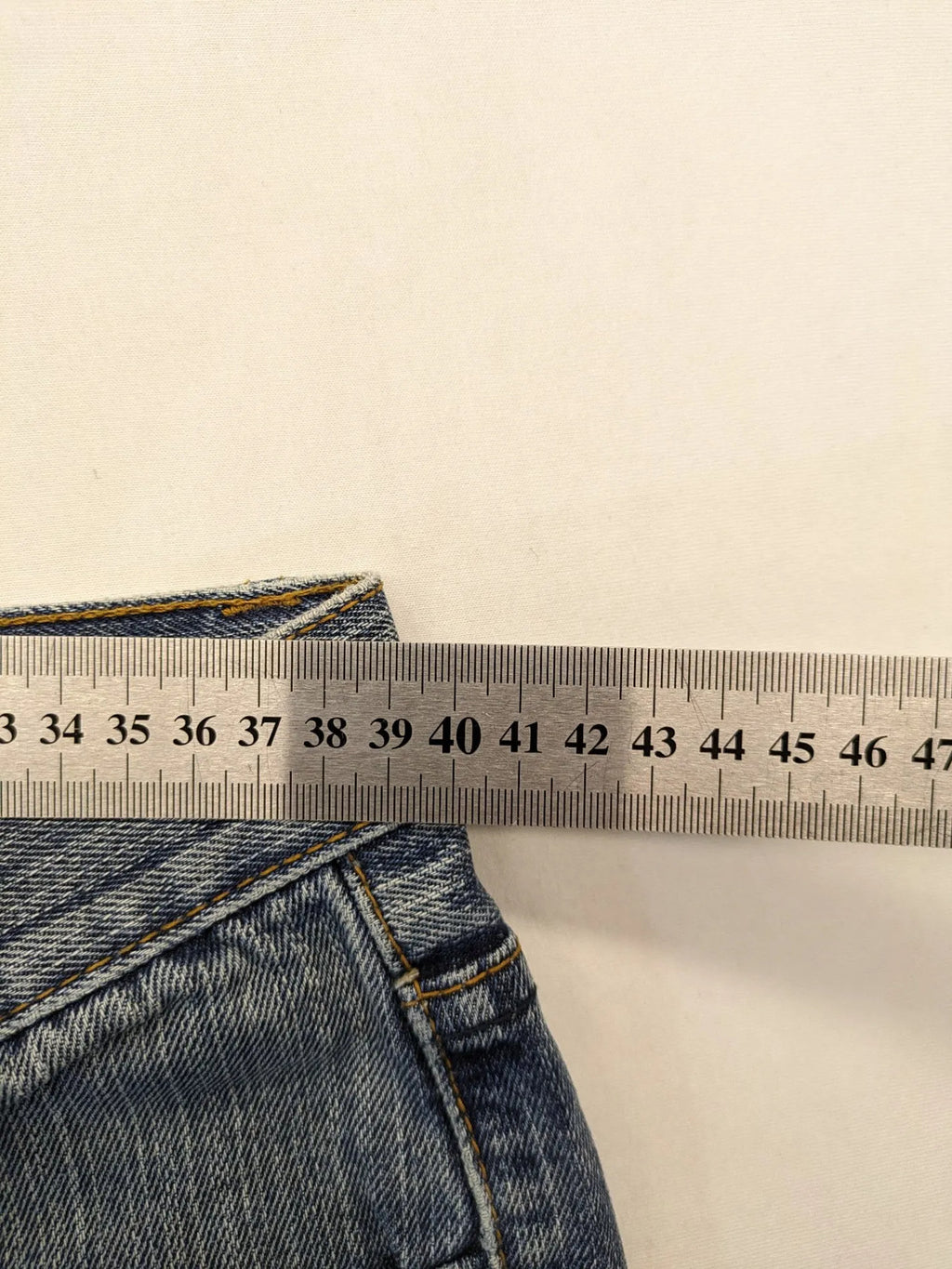 Zuni blue straight jeans 5-pocket design with zipper and decorative rivets.
