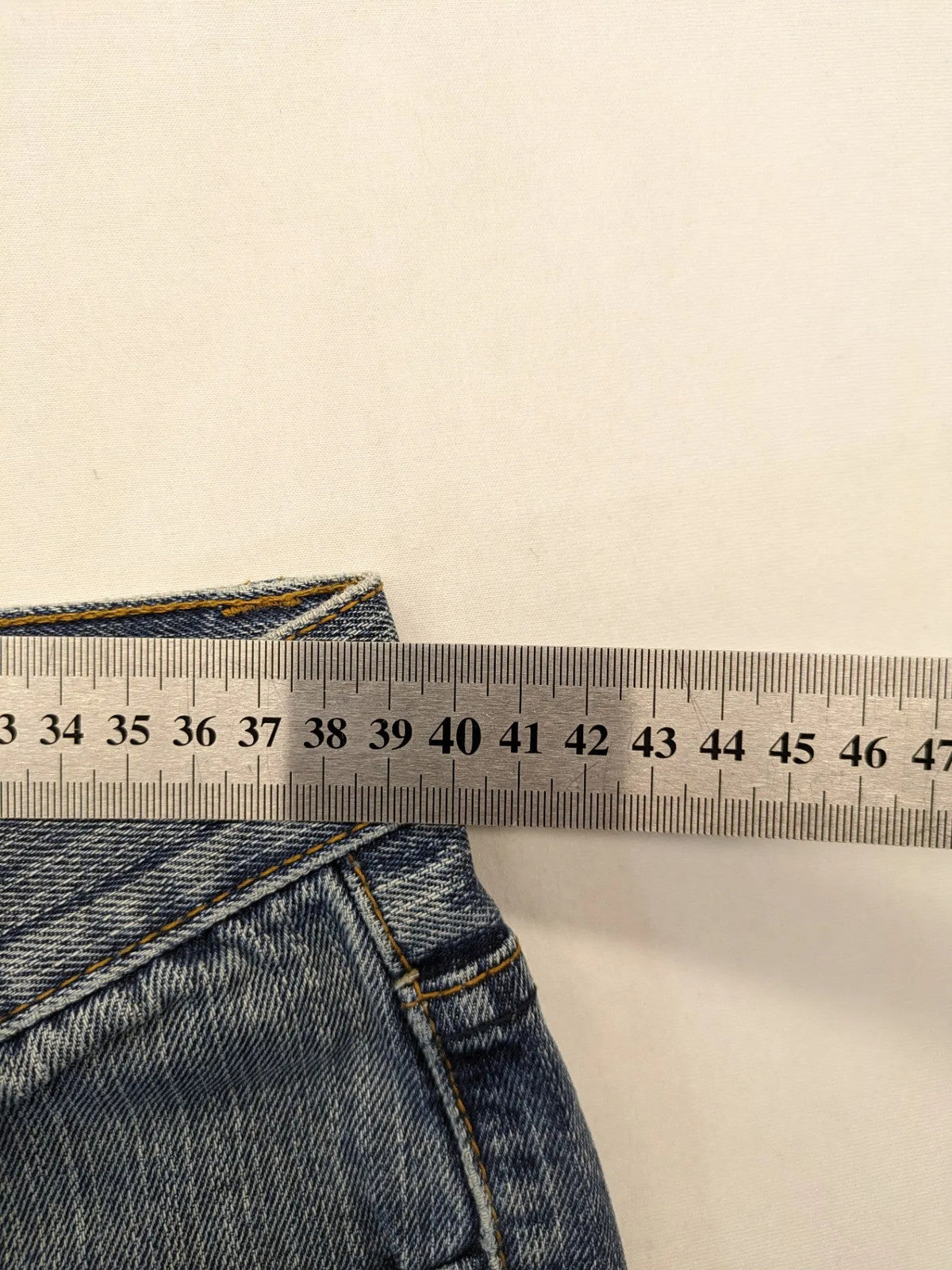 Zuni blue straight jeans 5-pocket design with zipper and decorative rivets.