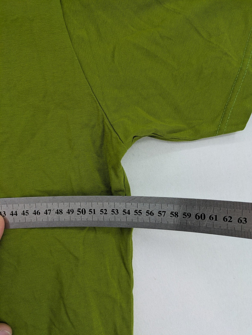 Lay Back green t-shirt with skull graphic, logo print, and short sleeves.