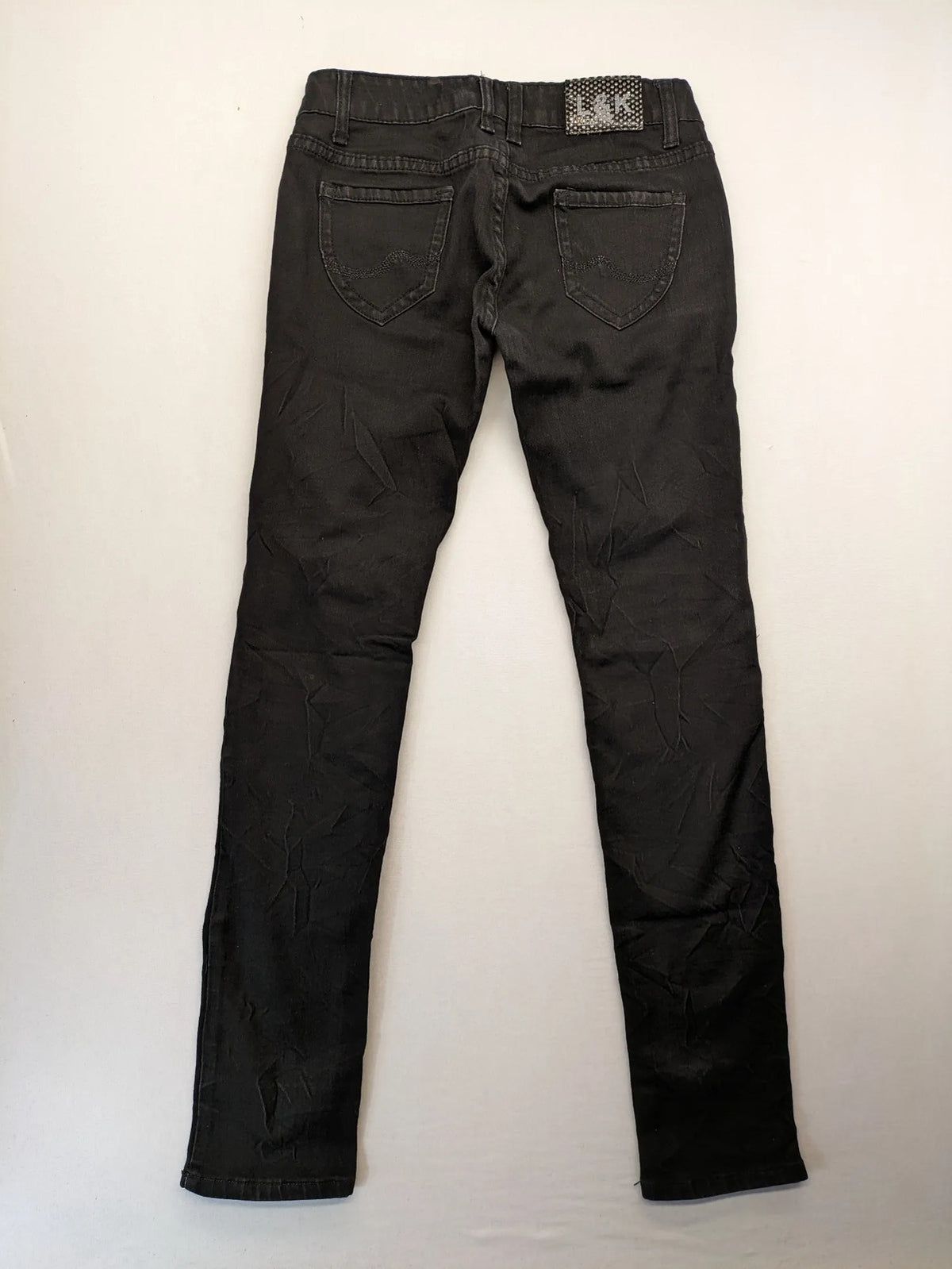 L & K Kaha black straight jeans with rhinestone logo patch and classic 5-pocket design.