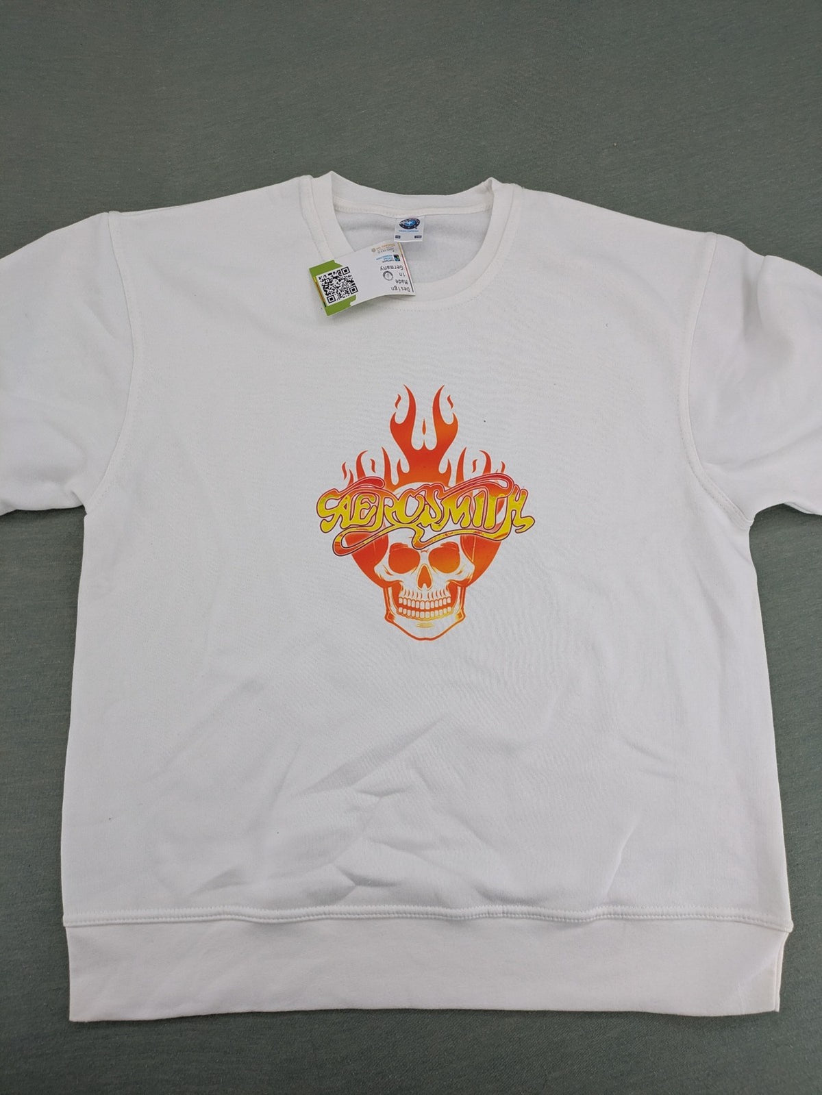 Aerosmith white sweatshirt with bold front graphic, logo, and flaming skull design.