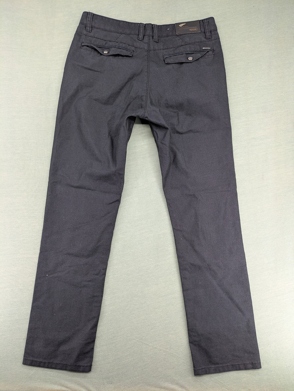 Rooney grey chino pants with checkered waistband and buttoned back pockets.