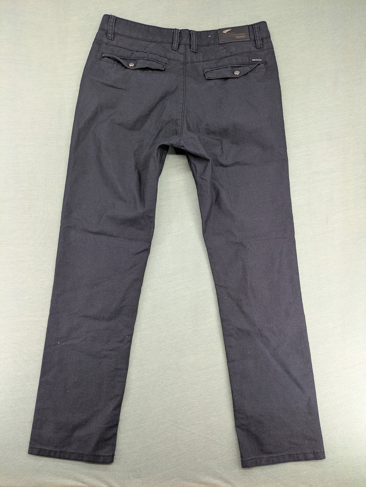 Rooney grey chino pants with checkered waistband and buttoned back pockets.