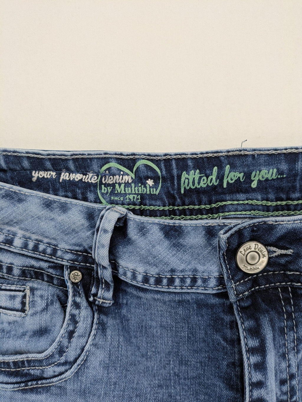 Multiblu blue straight jeans slim fit with decorative front zippers and light wash.