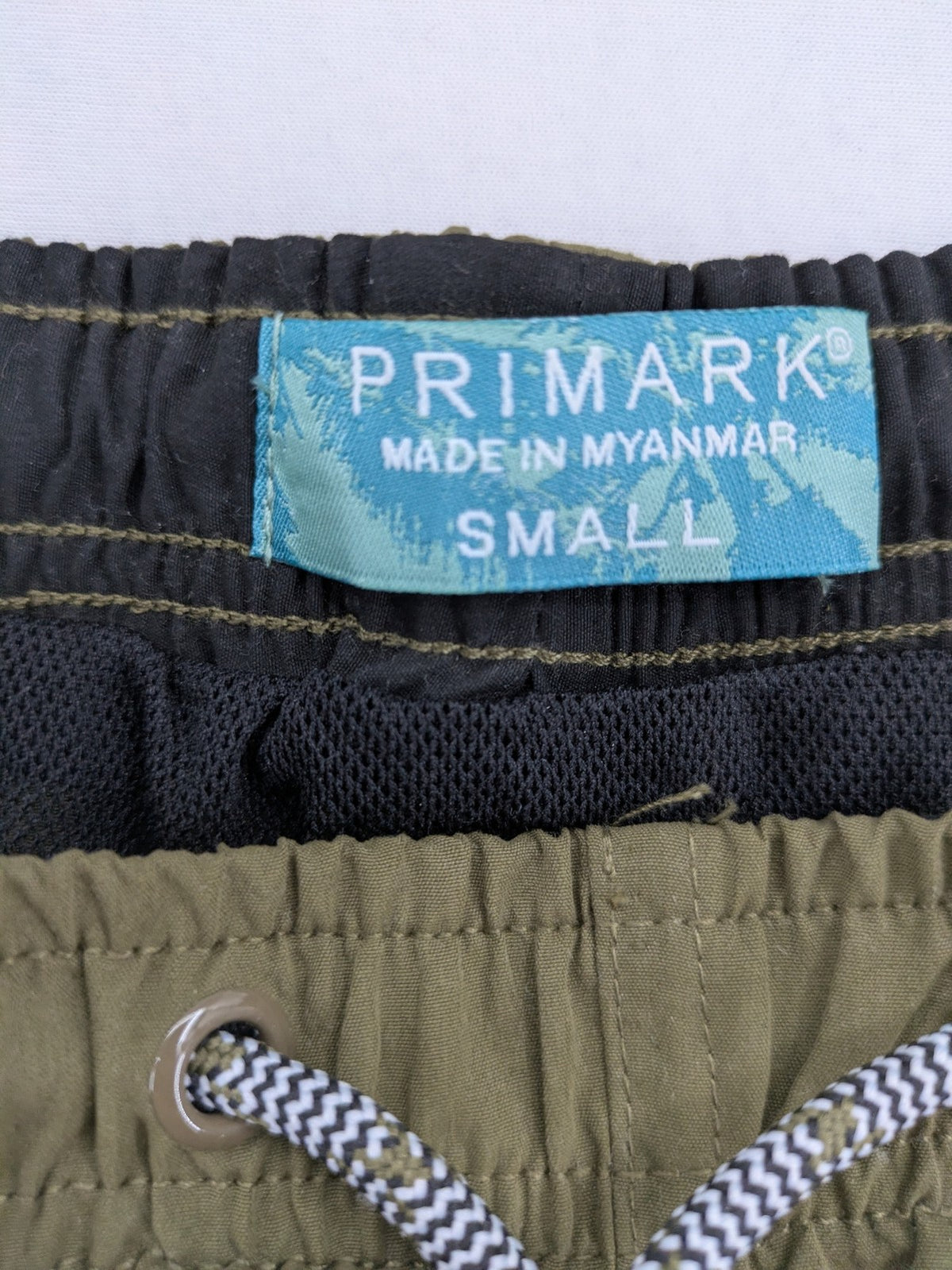 Primark khaki swim shorts size S with elastic waistband and back pocket.