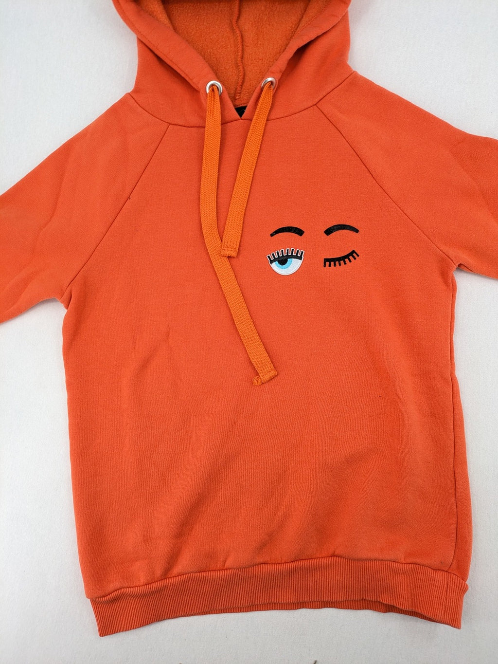 Ginatricot orange hoodie with embroidered winking eye detail, soft material, classic fit.