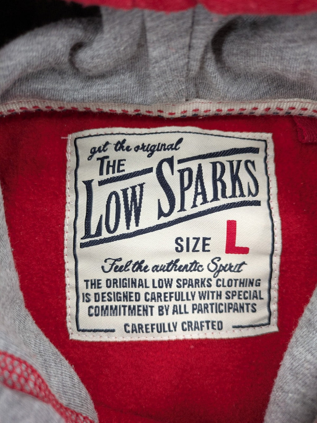 Sparks red zip-through hoodie with New York graphic print and grey hood.