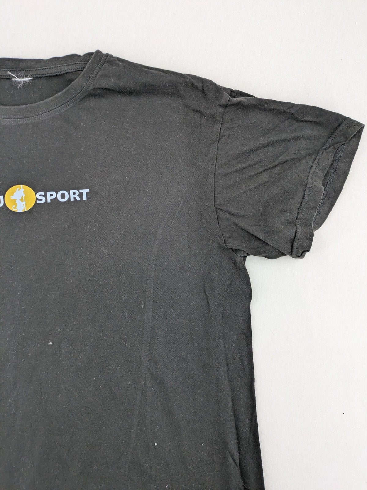Dragon Ball Z black t-shirt featuring Goku Sport logo and silhouette on Flying Nimbus.