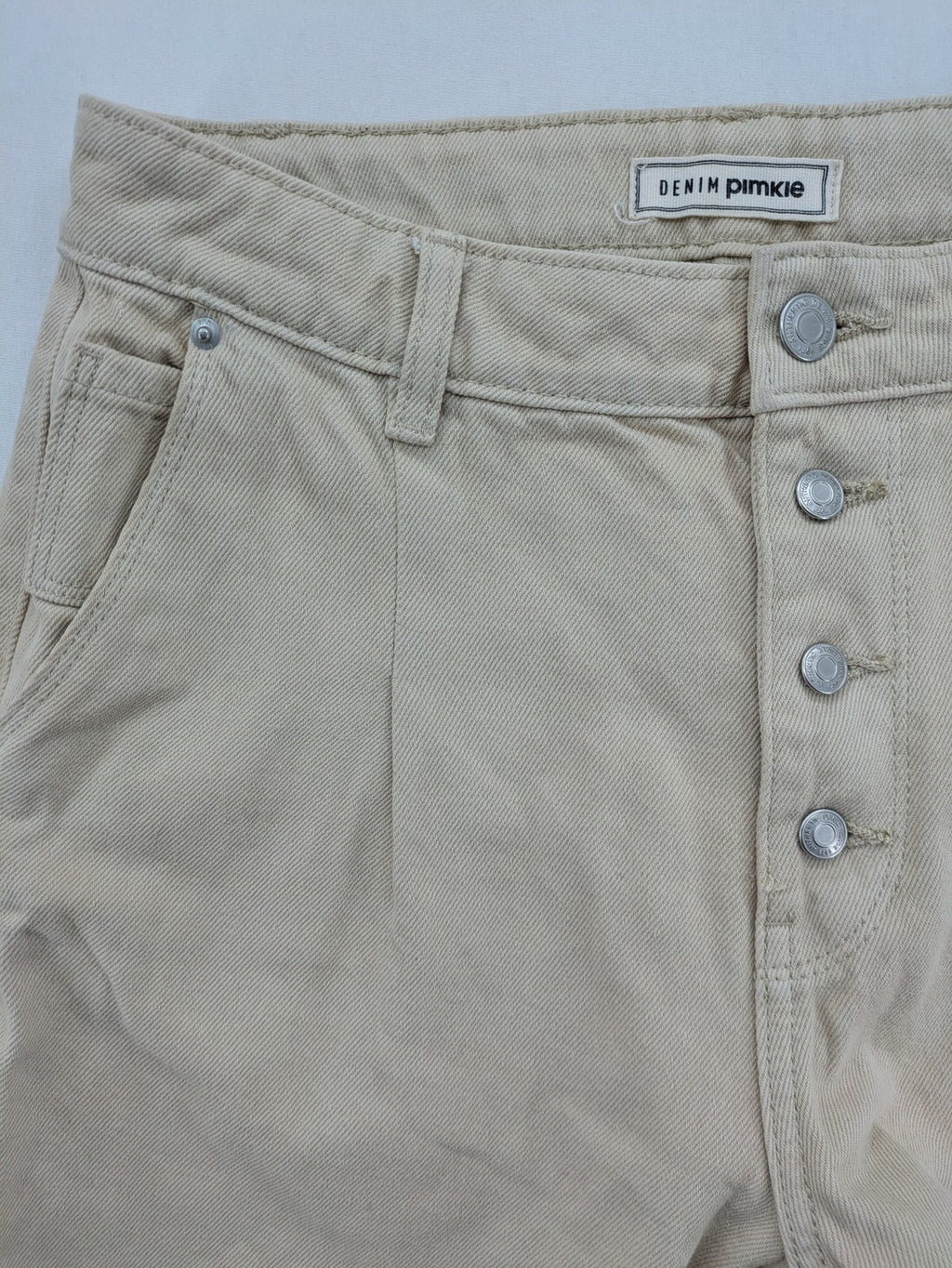 Pimkie beige mom jeans high waist tapered fit with front button placket and cotton material.