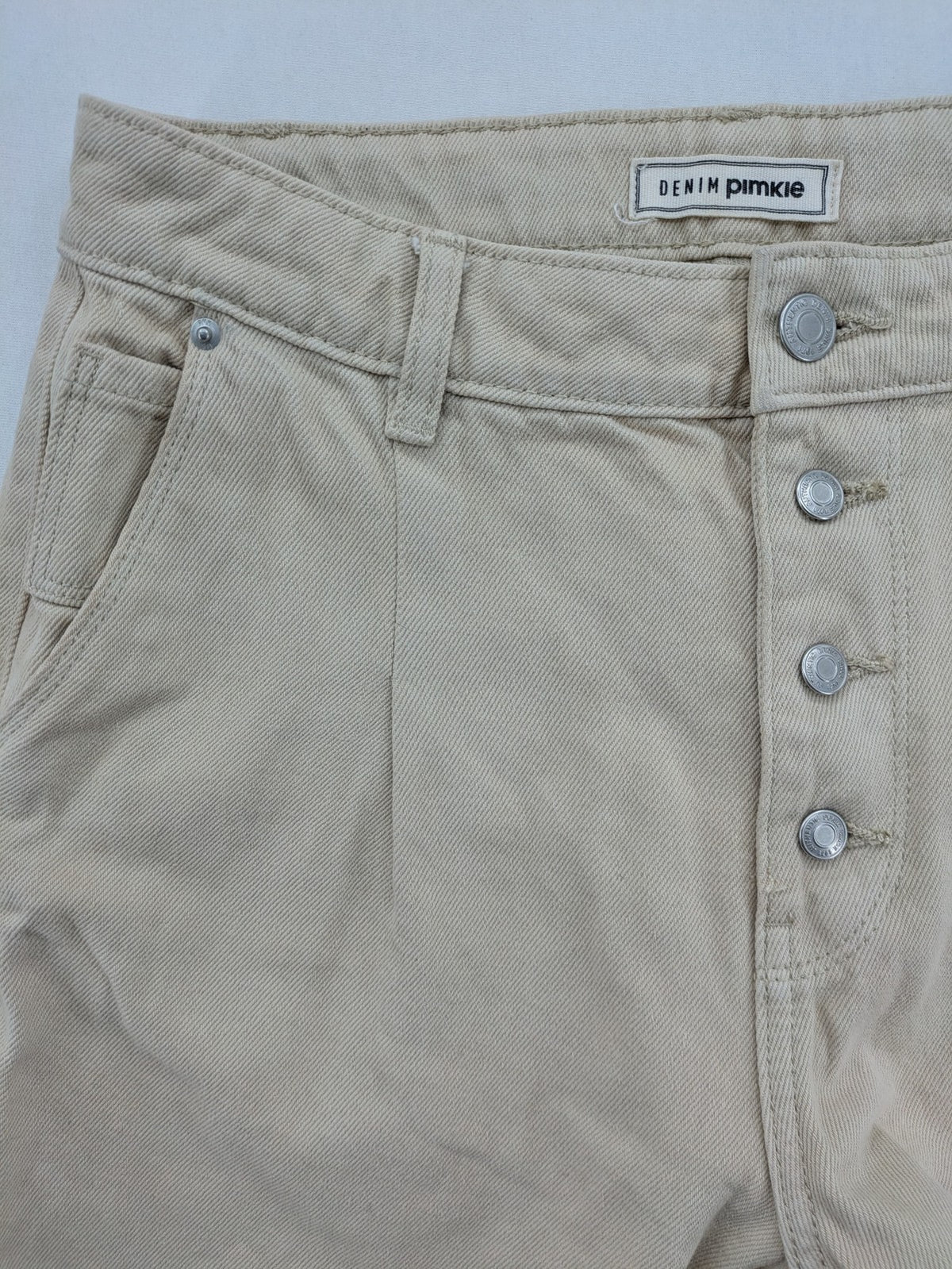 Pimkie beige mom jeans high waist tapered fit with front button placket and cotton material.