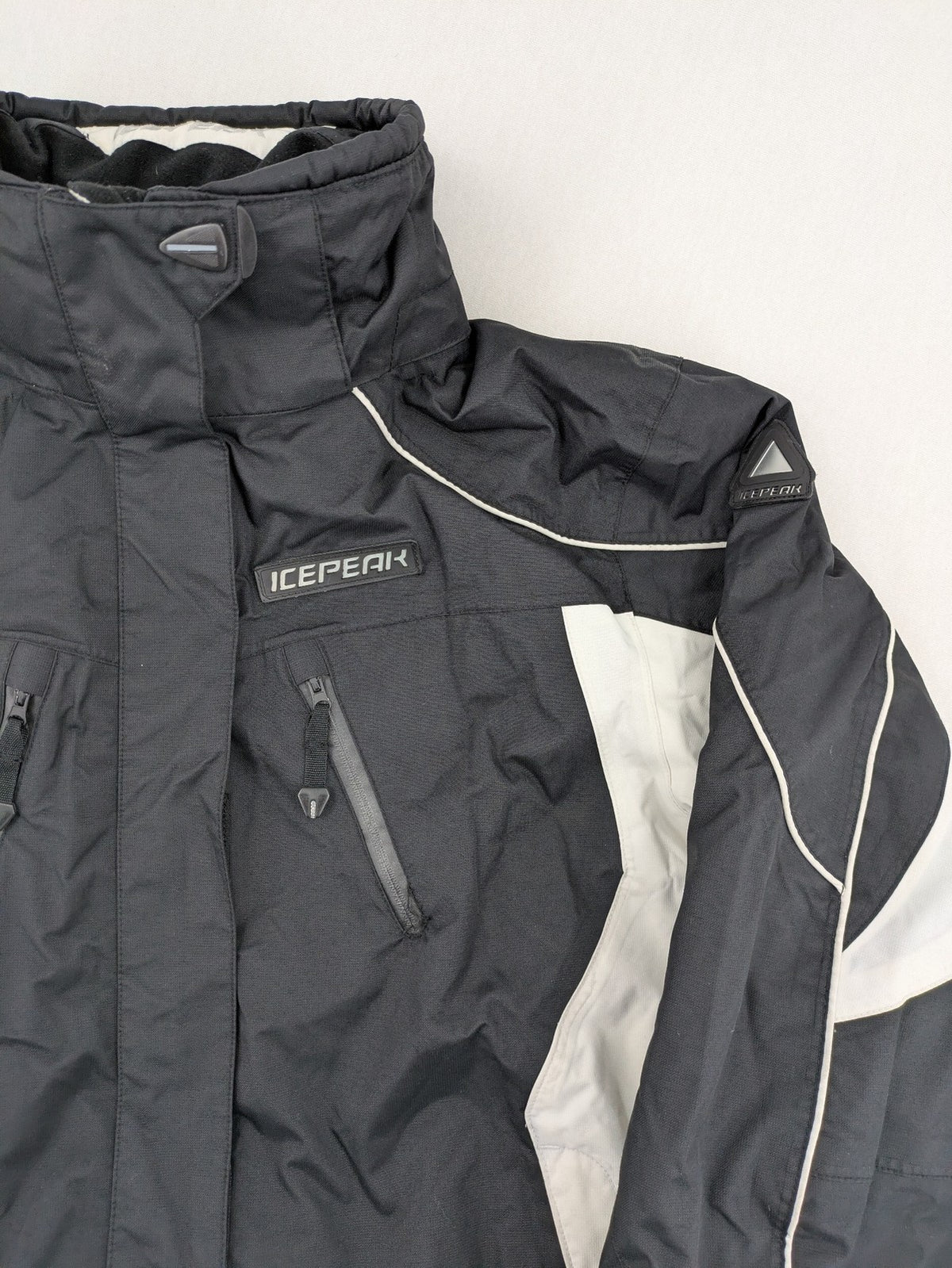 Icepeak black and white ski snowboard jacket with RECCO logo and quilted insulation.
