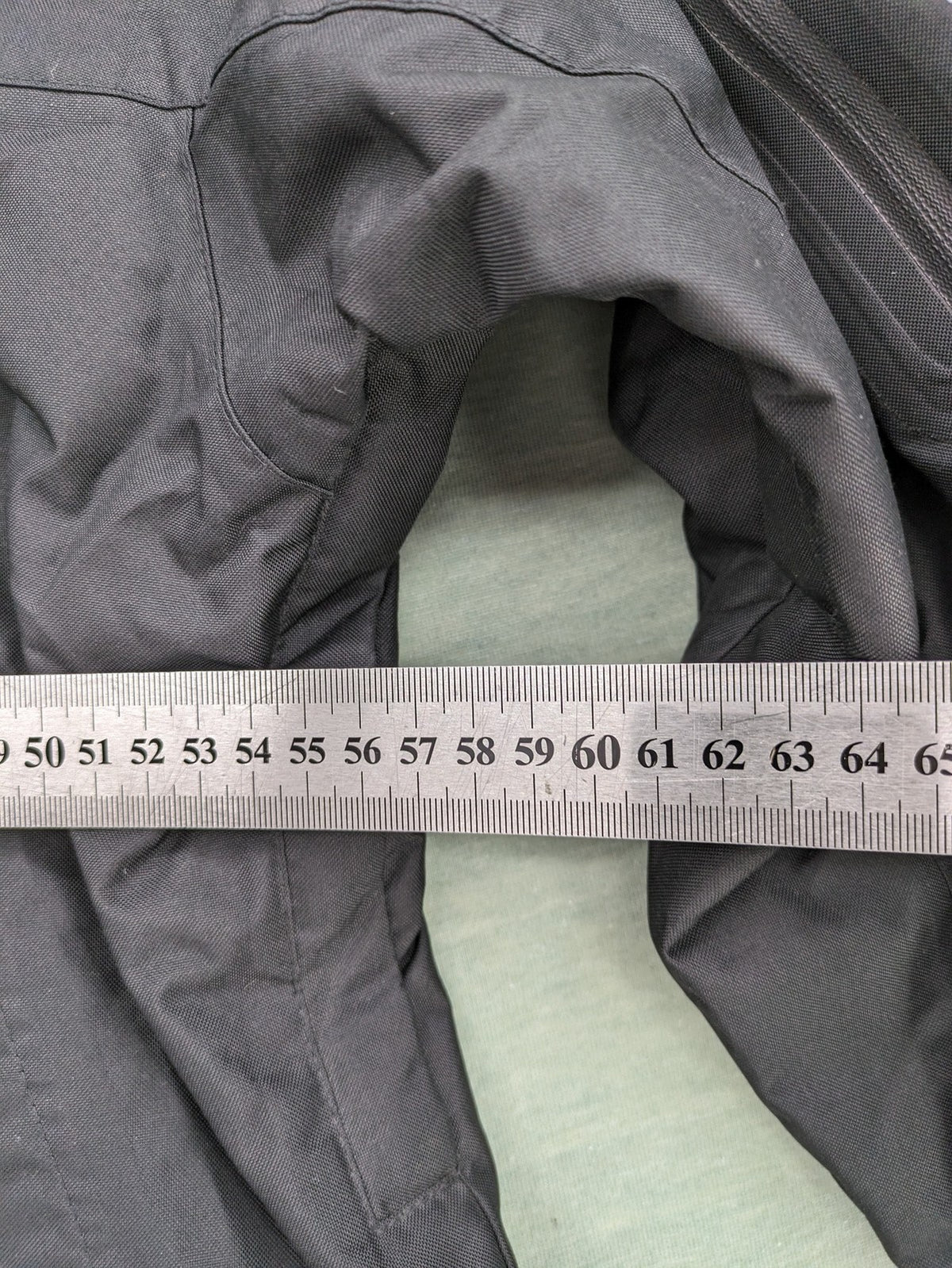 Stormtech black waterproof jacket with ZF logo, H2Xtreme technology, front zipper, and hood.