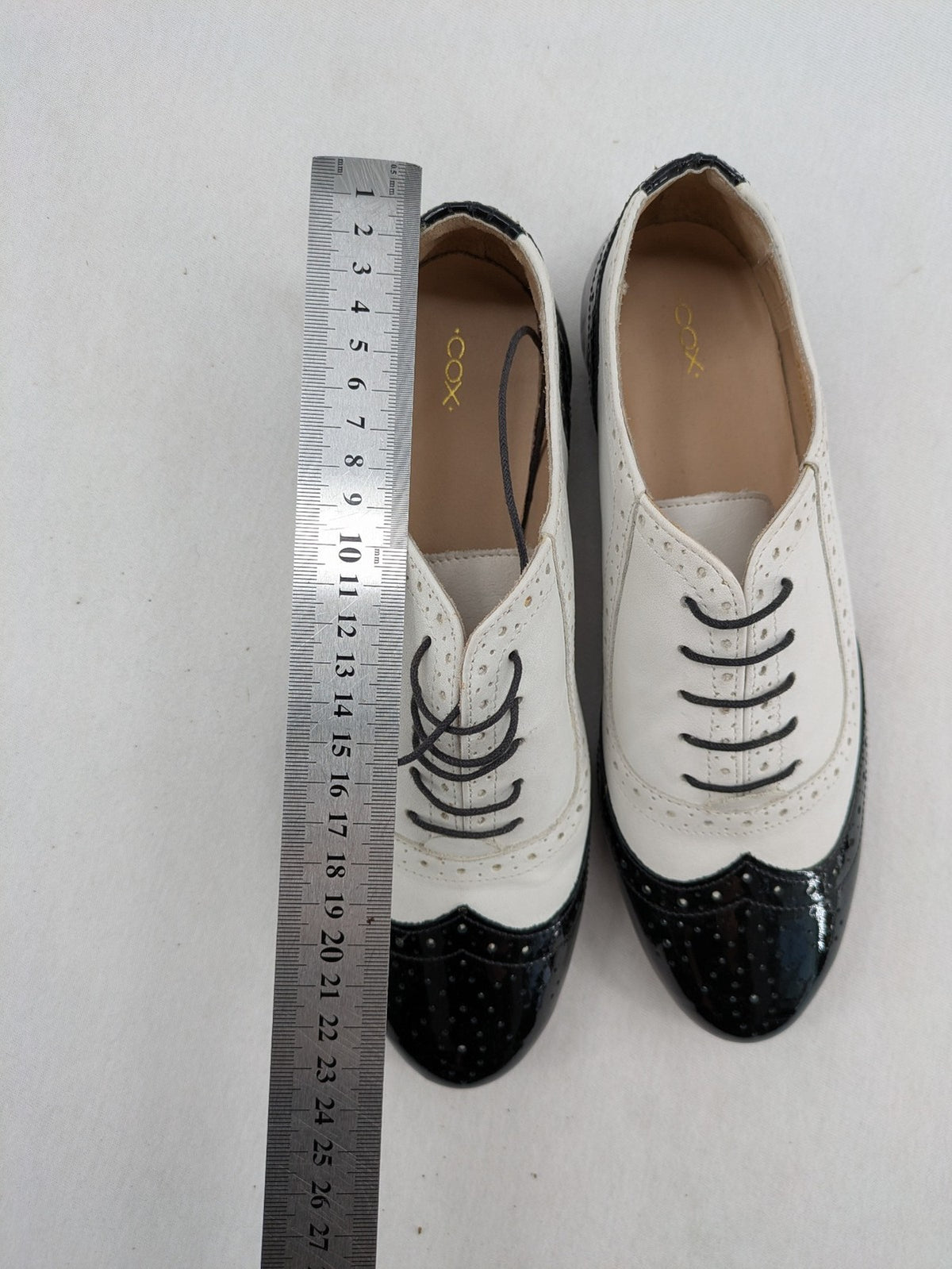 Kontrast black and white deck shoes, glossy patent leather with wingtip cap and brogue detailing.