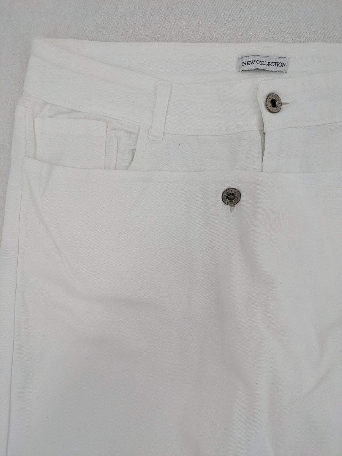 New Collection white straight jeans asymmetrical wrap design with side lacing and cotton-stretch material.