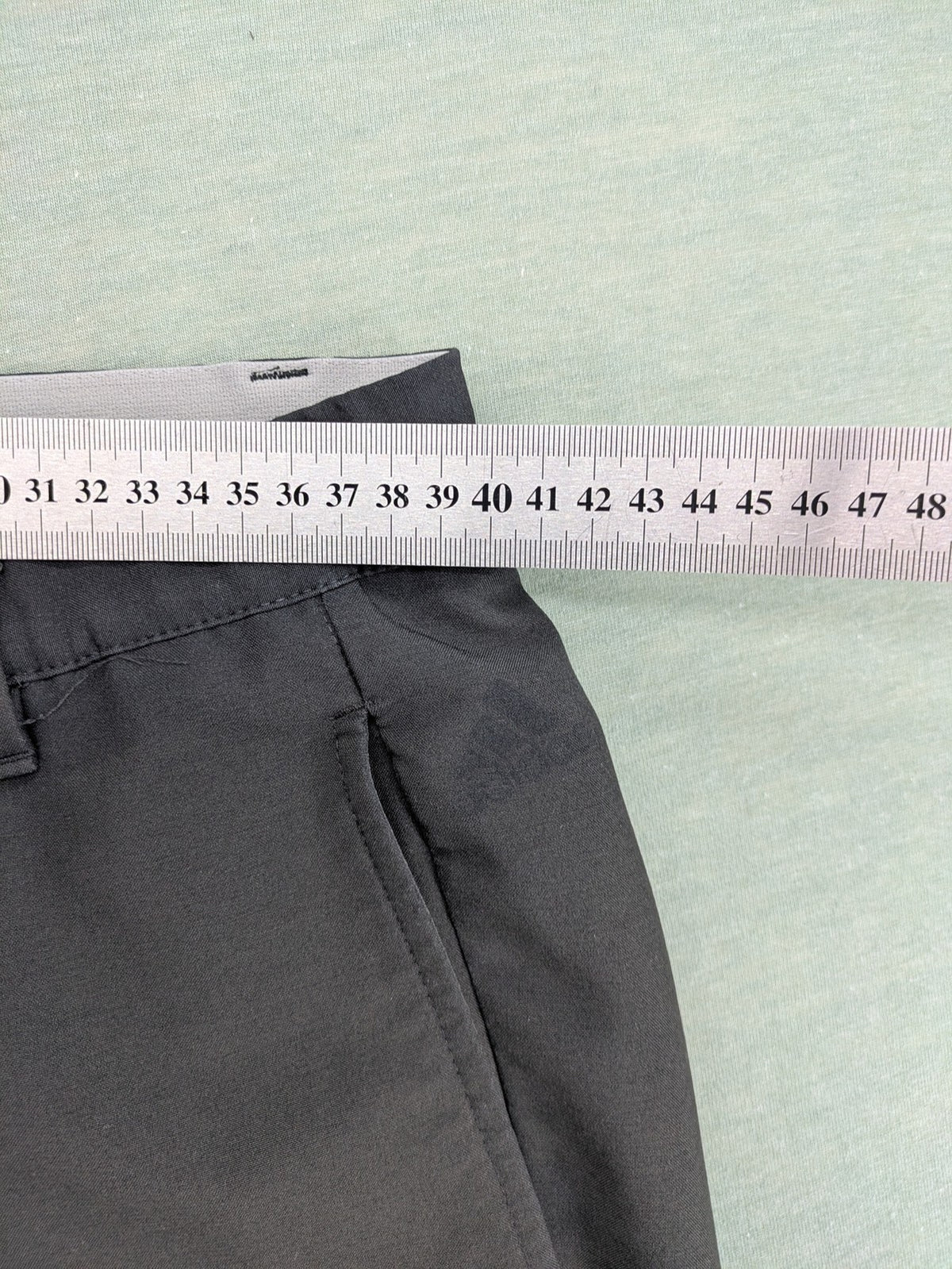Adidas grey pants with 3-stripe logo, flat-front design, made from performance material.