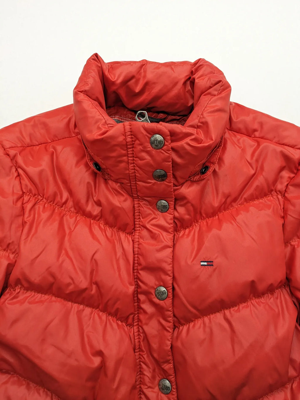 Hilfiger Denim red down jacket with quilted design, stand collar, and zip closure.