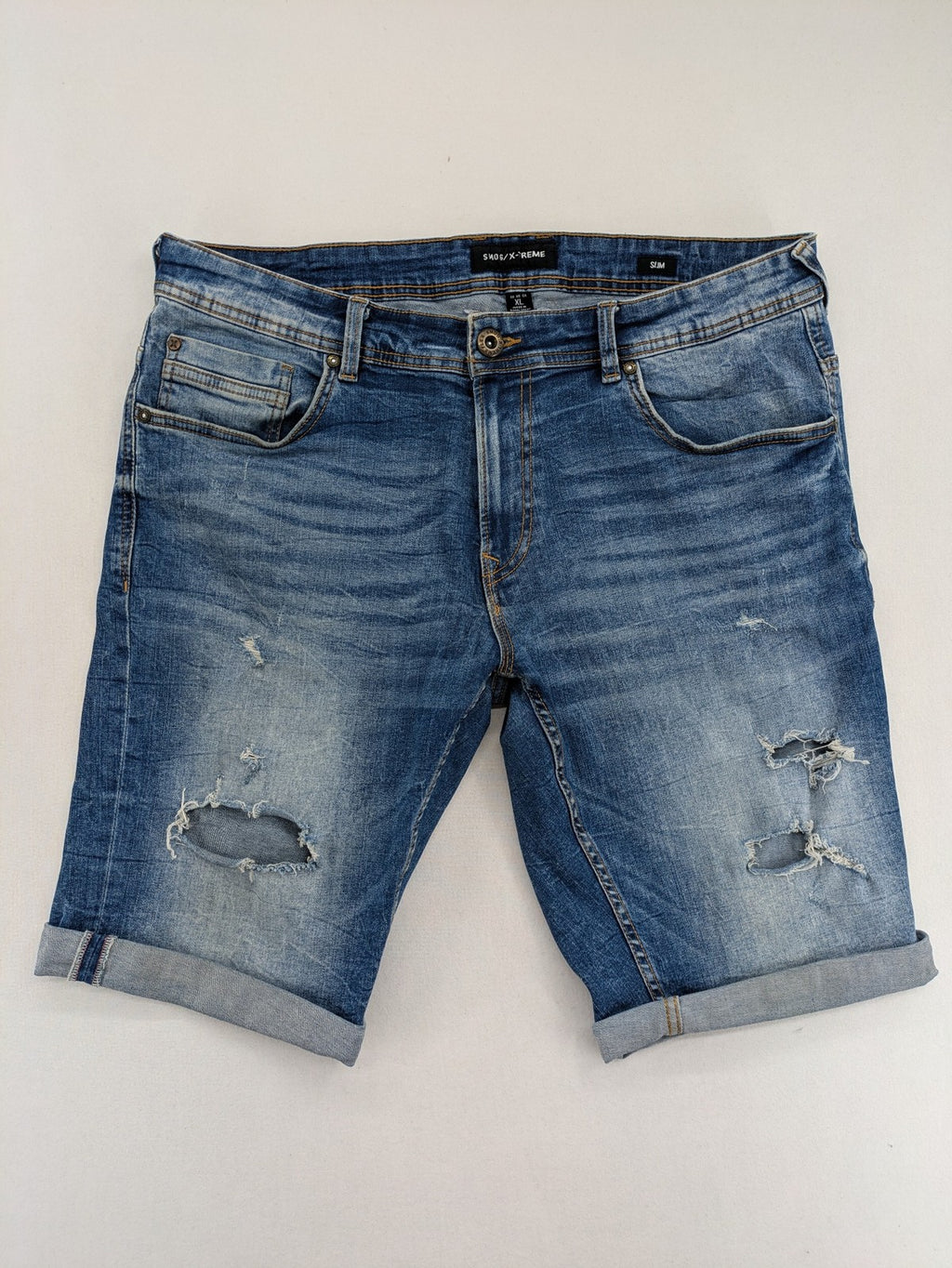 Smog blue denim shorts slim fit distressed details with rolled hem.