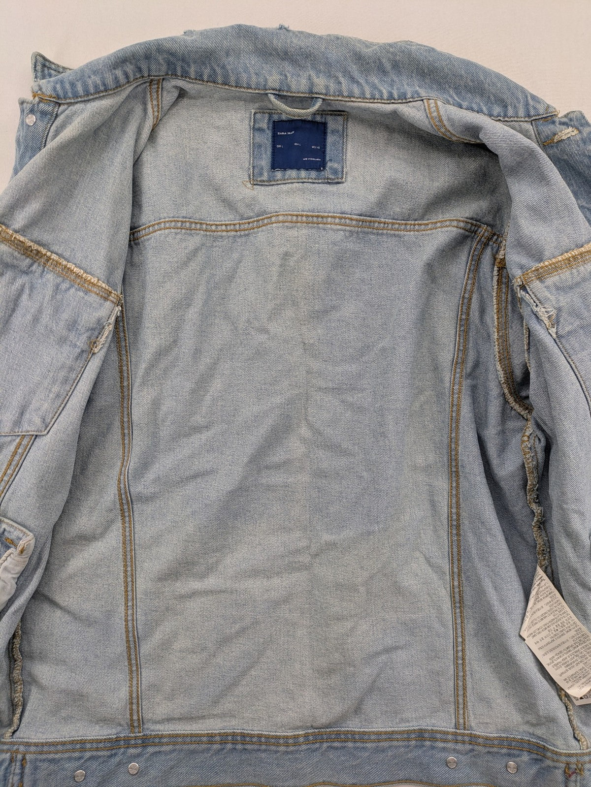 Zara Man blue denim jacket distressed with button closure and chest pockets.