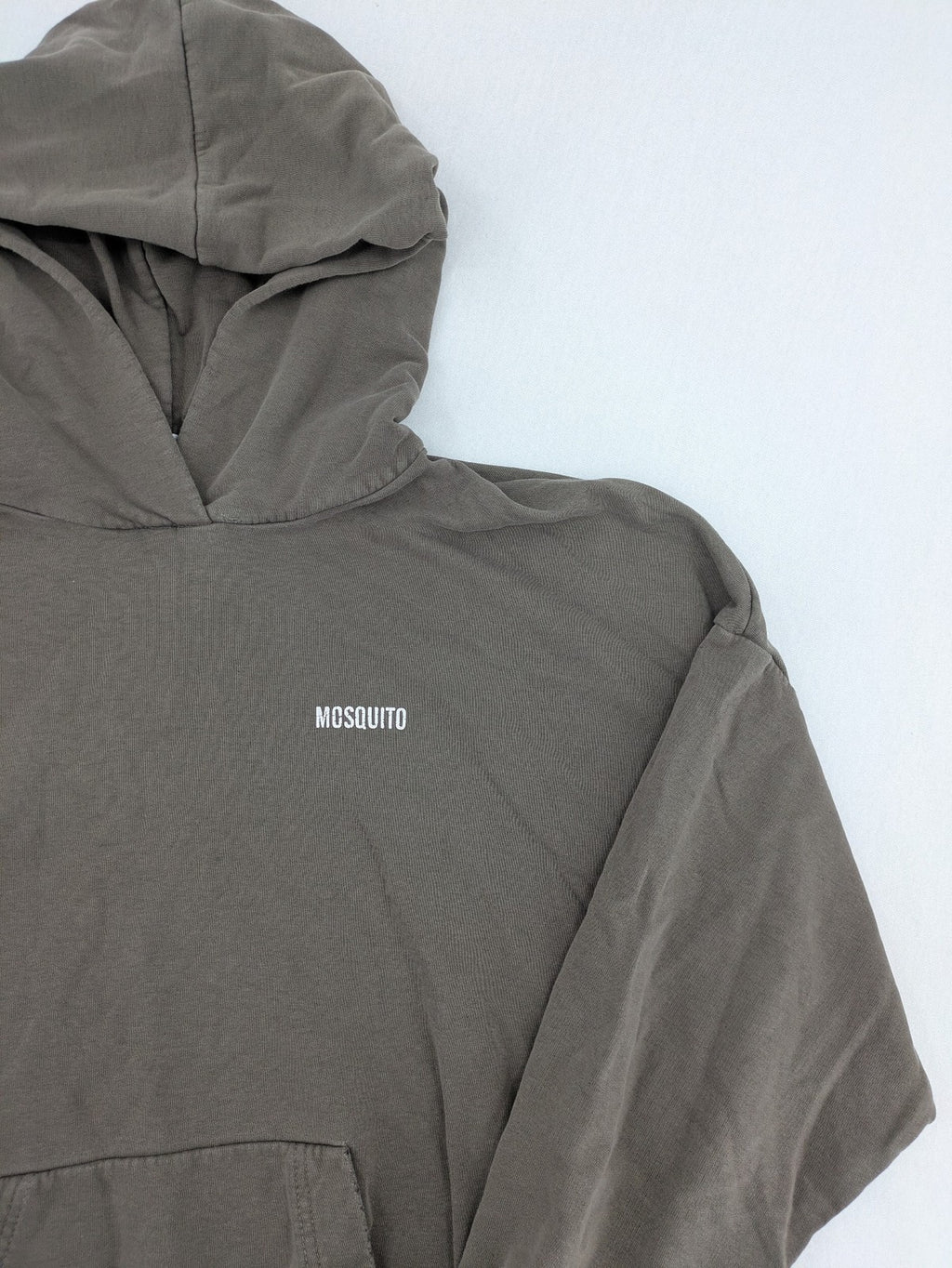 Mosquito grey hoodie with distressed cuffs and subtle logo on the chest.