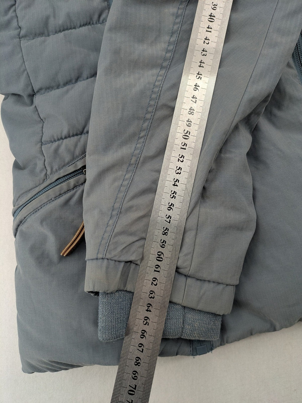 Naketano blue jacket with teddy fleece lining, hood, and leather appliqués.