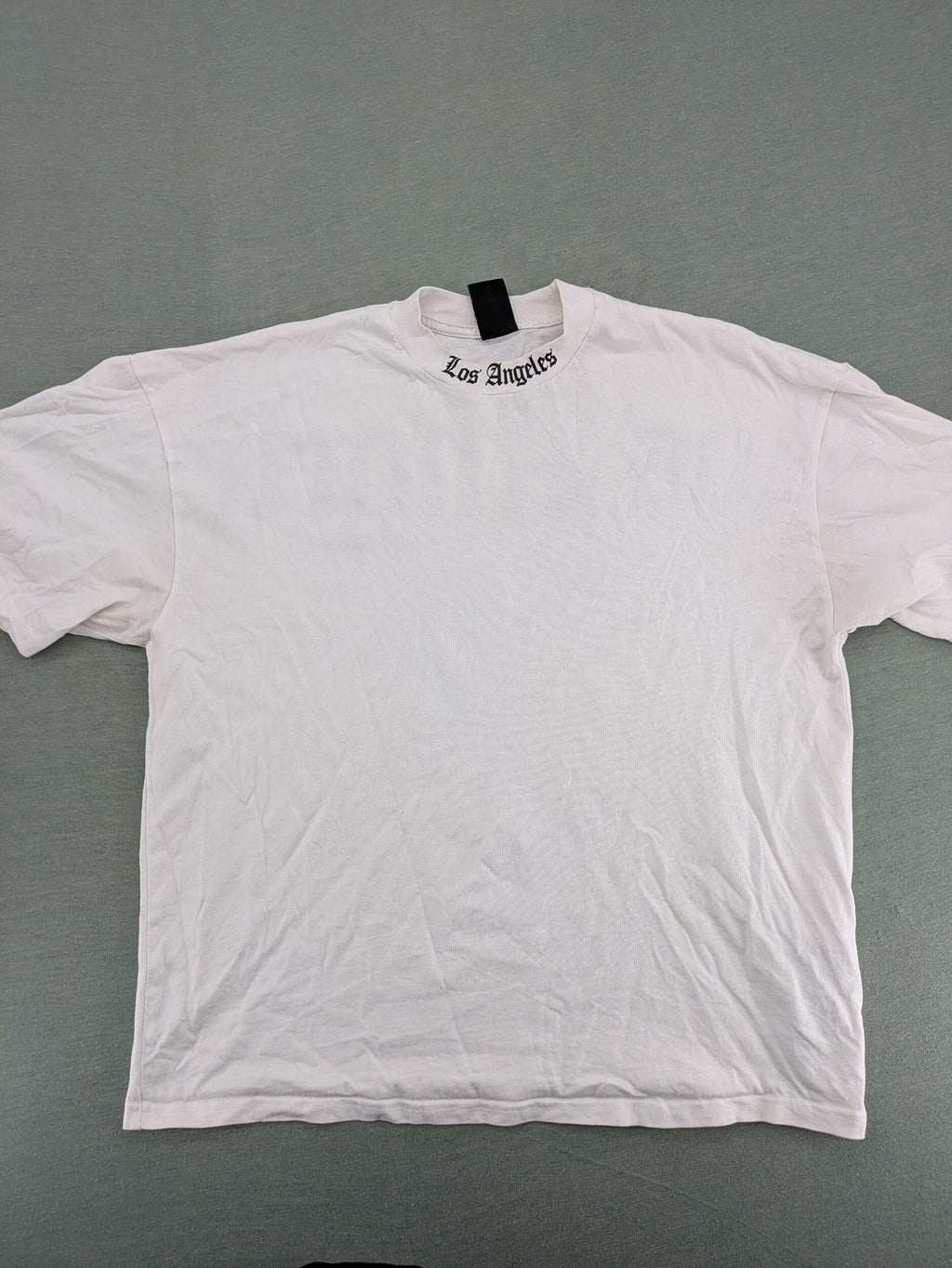 Black Squad black oversized t-shirt with white "Los Angeles" backprint and cotton material.