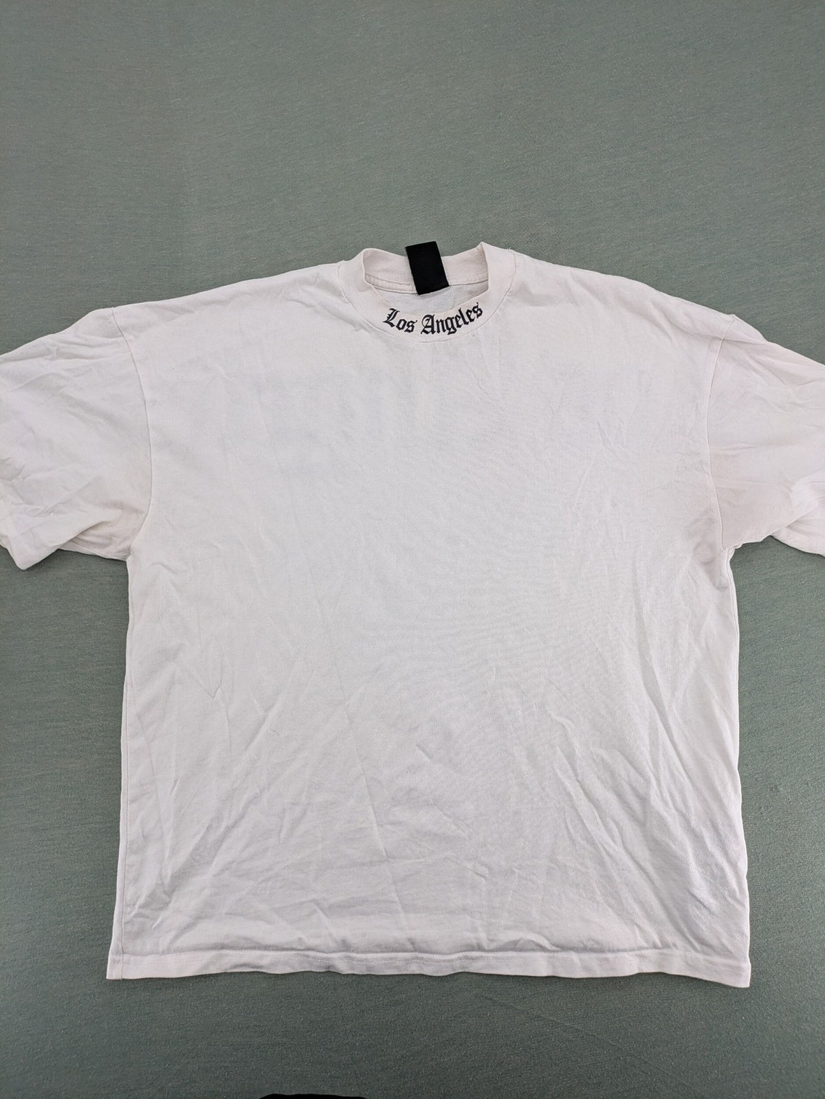 Black Squad black oversized t-shirt with white "Los Angeles" backprint and cotton material.