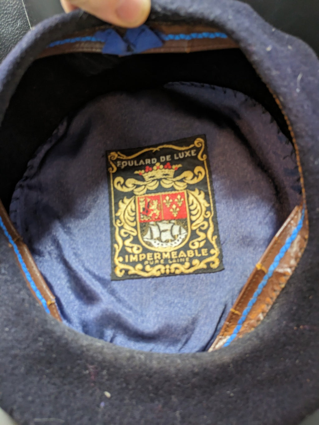 Luxe navy beret pure wool waterproof with emblem lining and leather band.