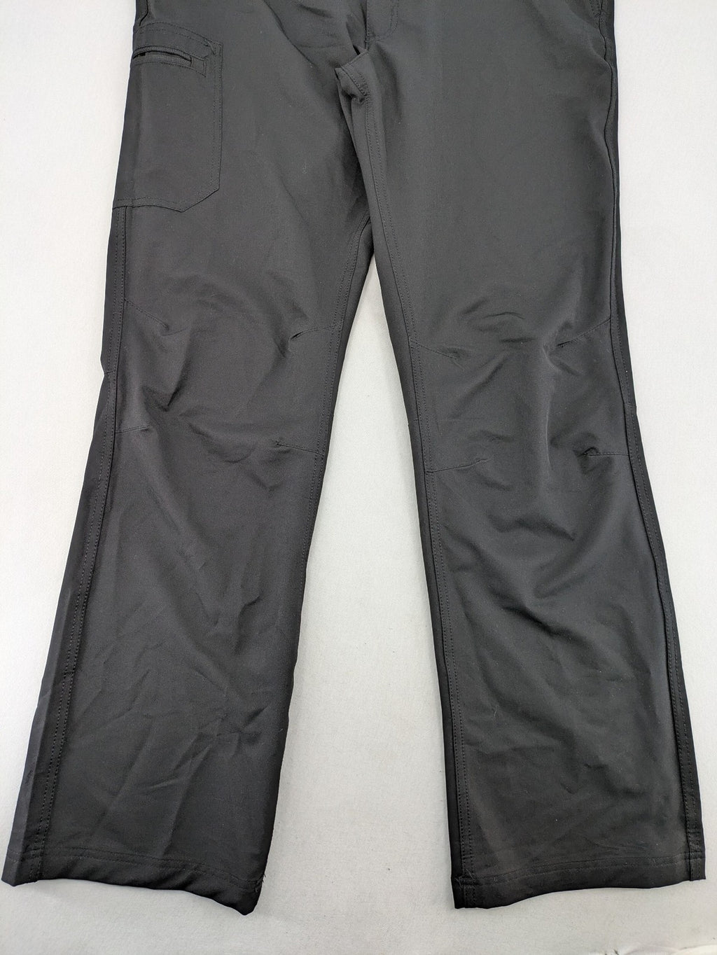 Outdoor grey trekking pants with zippered cargo pockets and durable stretch fabric.