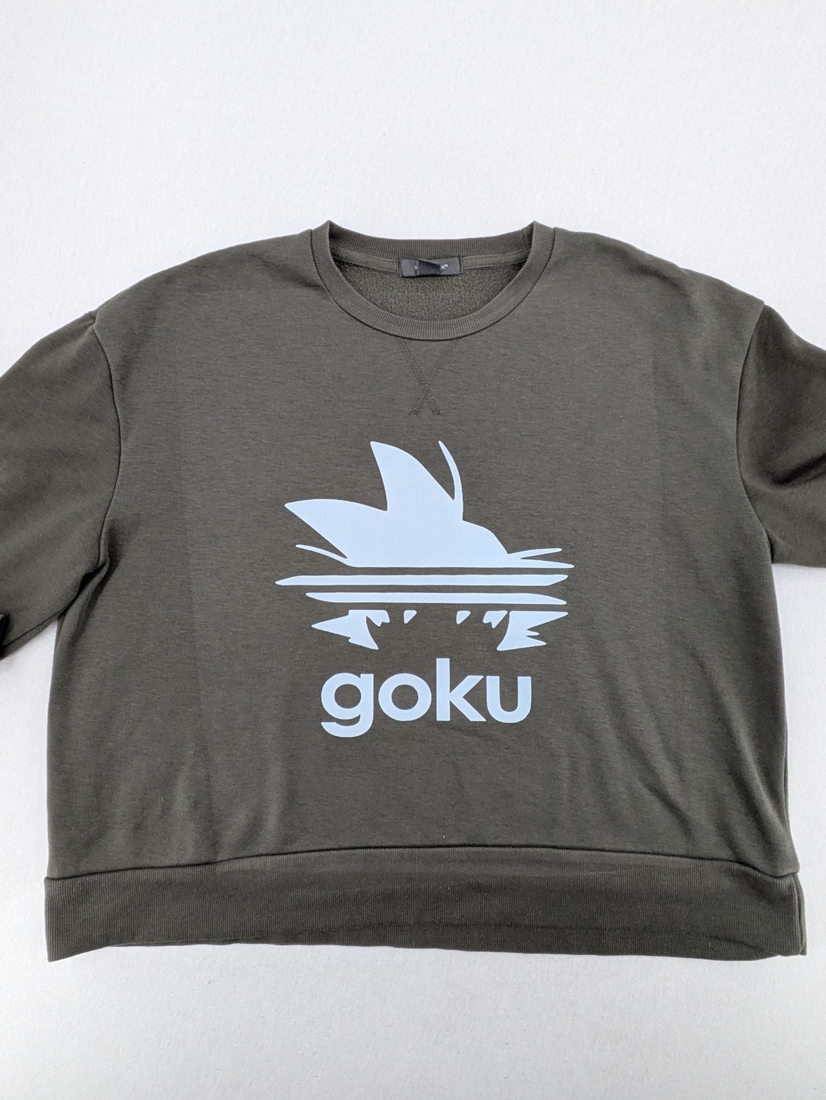 Dragon Ball Z blue sweatshirt featuring Son-Goku graphic and Primark logo.
