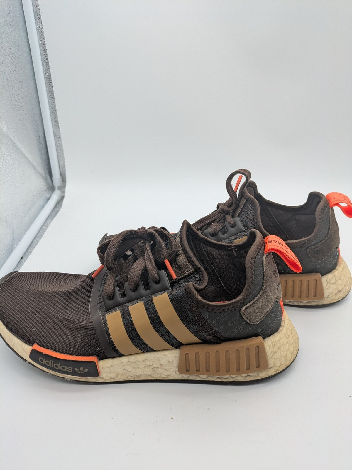 Adidas NMD R1 sneakers brown with tan stripes and bright orange accents, Boost sole.