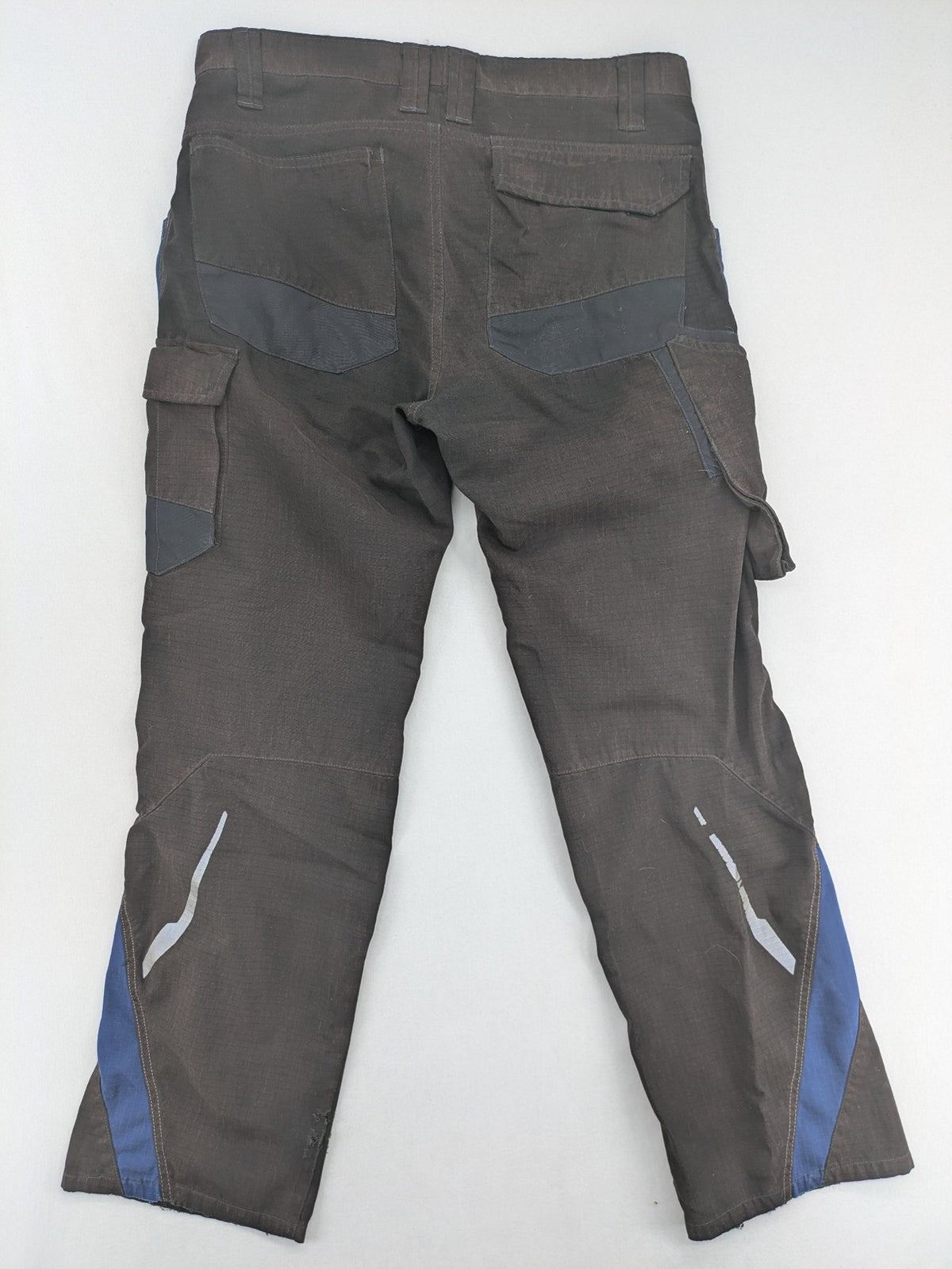 Kübler work pants blue grey Cordura fabric with multiple cargo pockets and reflective details.