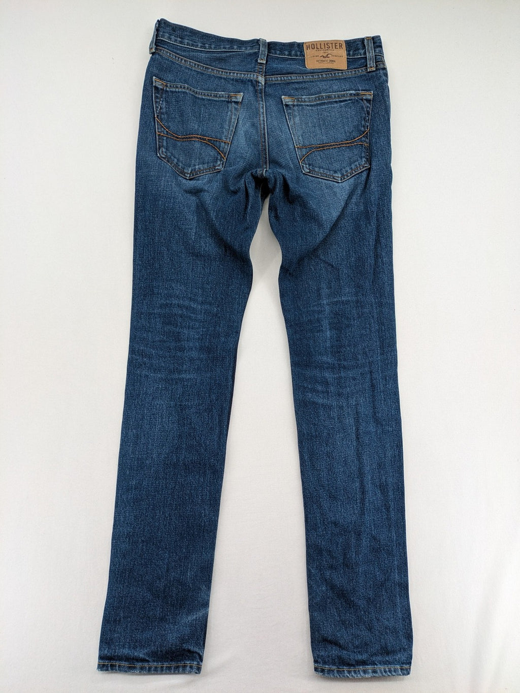 Hollister blue super skinny jeans medium wash button fly with faded details.
