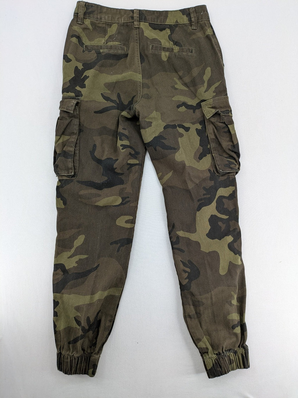 Rainbow camouflage cargo pants in green-brown with jogger silhouette and multiple pockets.
