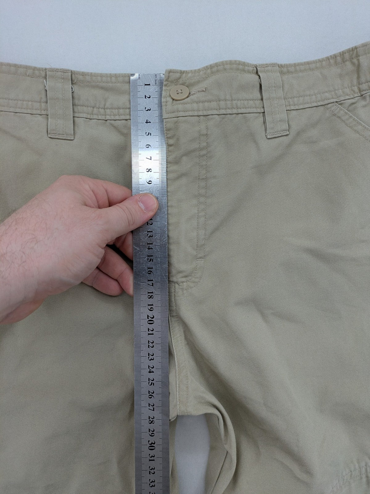 Quechua khaki convertible hiking pants with zip-off legs and durable cotton fabric.