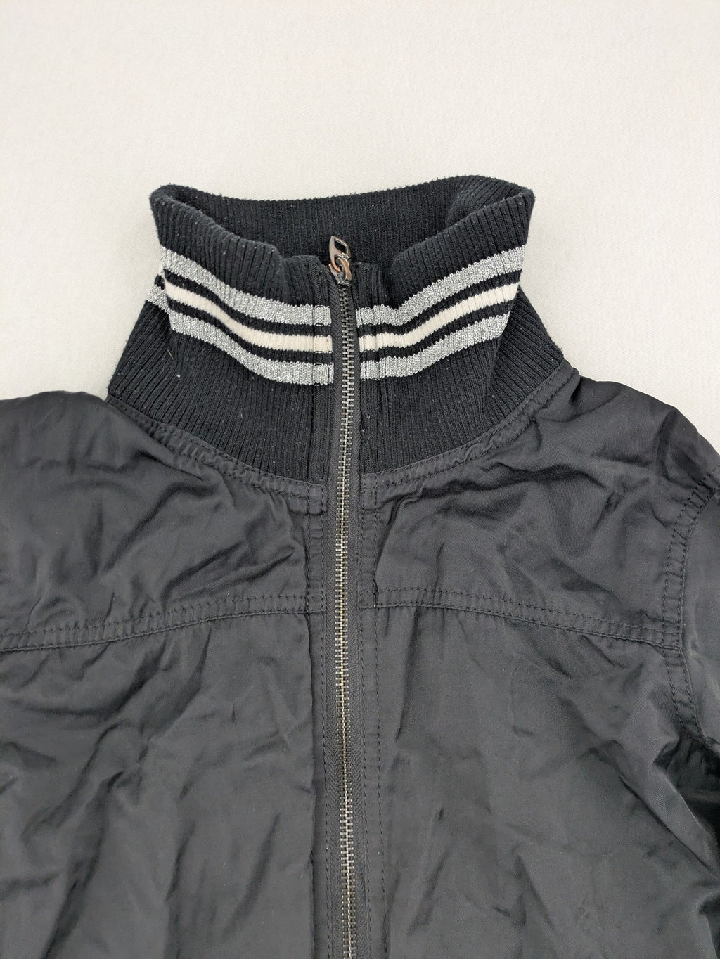 Ann Christine black bomber jacket with striped ribbed collar and cuffs, zip closure.